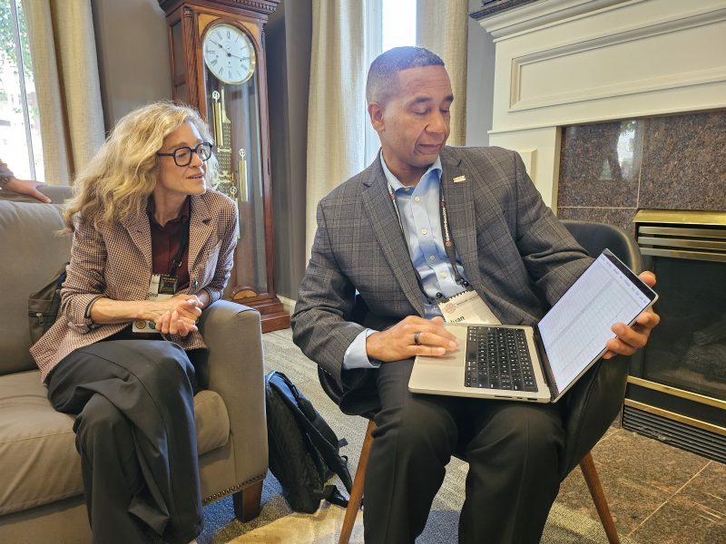 Juan Gilbert demonstrates Applications Quest to attendee Regina Nuzzo