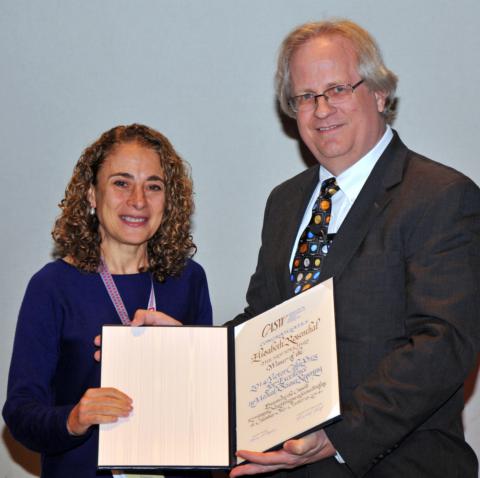 Elizabeth Rozenthal accepting the Cohn award certificate from CASW President Alan Boyle